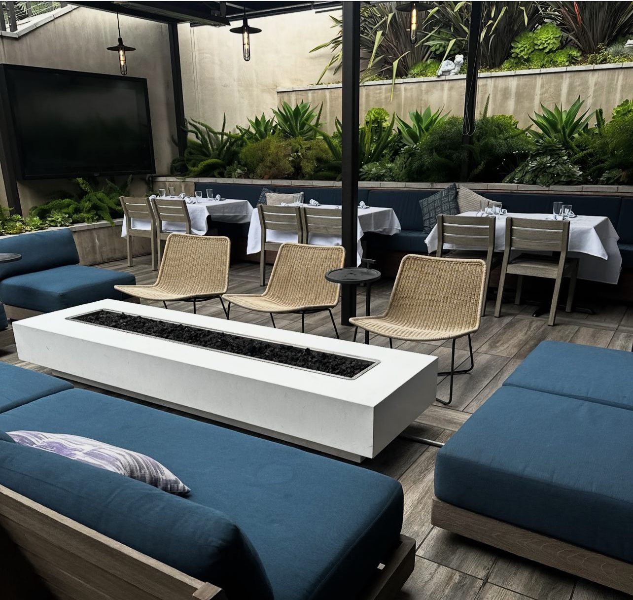 The covered garden patio, fire pit, and outdoor television at LOCAL Montecito
